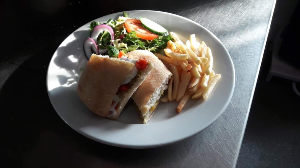 A Cafe Dino sandwich lunch with chips and salad
